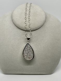 Charles Albert Designer Fossil Coral Teardrop Pendant set in Fine Sterling Silver ( .950 ). Lovely Gray and Red color Fossil Coral Teardrop Pendant is 1.9 x 1.2 inches around and hangs 2.5 inches from the top of the generous Fine Sterling Silver bail. This Teardrop Pendant is a double sided cabochon, nicely domed and open to the back of the pendant. All Handmade. Lovely swirling shades of Gray and Red with Fossil imprints throughout this Teardrop Pendant, and has a generous bail to accommodate c Silver Drop Necklace With Cabochon, Silver Teardrop Jewelry With Stone Setting, Drop Shaped Cabochon Jewelry For Anniversary, Silver Teardrop Pendant Jewelry With Bezel Setting, Teardrop Cabochon Jewelry For Anniversary, Teardrop Cabochon Necklace For Anniversary, Silver Pear-shaped Cabochon Jewelry, Anniversary Teardrop Cabochon Jewelry, Anniversary Cabochon Teardrop Necklace