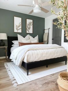 a bedroom with a bed, ceiling fan and rug in the middle of the room