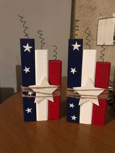 two wooden blocks with stars painted on them sitting on a table next to each other