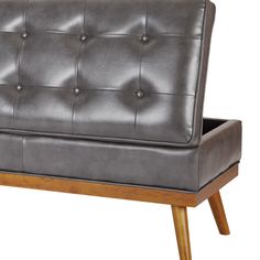 a gray leather couch with wooden legs