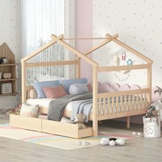 a child's bedroom with pink walls and wooden furniture, including a doll house bed