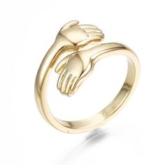 a gold ring with two hands on it