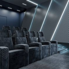 an empty movie theater with seats facing the screen