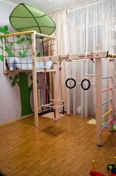 a child's play area with toys and climbing bars