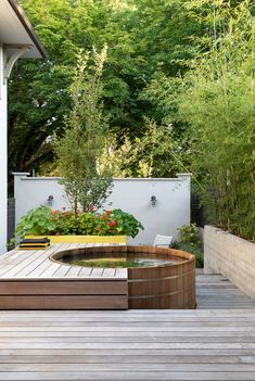 a wooden deck with a water feature in the middle