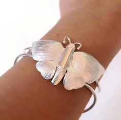 Butterfly cuff sterling silver, sterling silver butterfly bracelet cuff, butterfly silver, gift for her adjustable Embrace the beauty of nature with this exquisite Sterling Silver Butterfly Cuff Bracelet. Handcrafted with meticulous attention to detail, this stunning cuff features a beautifully detailed butterfly with intricately textured wings, capturing the delicate elegance of this beloved creature. The high-polish finish adds a touch of luxury, making it a perfect accessory for both everyday Butterfly-shaped Sterling Silver Bracelet, Silver Sterling Silver Butterfly Bracelet, Sterling Silver Butterfly Bracelets, Silver Bracelet With Butterfly Clasp For Gift, Butterfly Shaped Silver Bracelet Gift, Silver Butterfly Bracelets For Gifts, Sterling Silver Butterfly Bracelet, Silver Butterfly Bracelet For Gift, Silver Bracelet With Butterfly Clasp