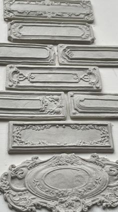 several decorative plaques and frames are shown in black and white, as well as some type of mold