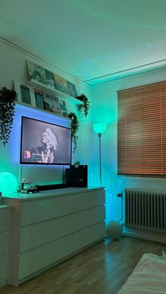 a room with a television, radiator and green lights