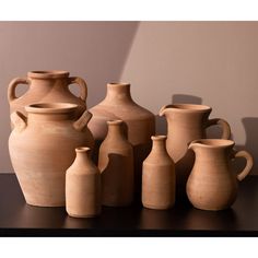 a group of vases sitting on top of a table