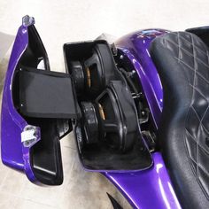 a close up of a purple motorcycle with the seat removed from it's side