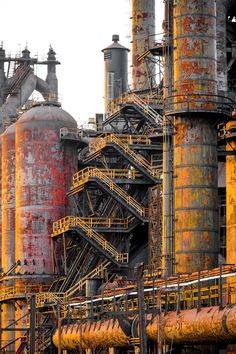 an industrial factory with large pipes and yellow paint