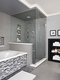 a bathroom with a walk in shower next to a bath tub