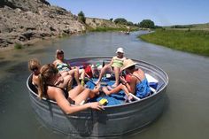 several people are sitting in a boat on the water