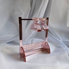 a pink metal stand with two lights on it