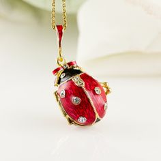 "Bright and festive ladybug locket with heart surprise inside, enameled over solid sterling silver, designed and made in our NJ shop in the tradition of Faberge jewelry. The egg shaped locket ladybug with bright purple wings and a black head, will open to show the red heart inside the locket, steadily fixed in its place. Clear Swarovski crystals are set in the center of the heart, as well as in the dots of the bug and its eyes. The locket is almost 1\"(25 mm) long. You will receive the pendant r Enamel Jewelry As A Gift For Her, Enamel Jewelry As Gift For Her, Enamel Locket Jewelry For Anniversary, Enamel Pendant Jewelry Gift, Enamel Pendant Jewelry For Gift, Enamel Locket Jewelry For Gifts, Enamel Hallmarked Jewelry For Gifts, Hallmarked Enamel Jewelry For Gifts, Personalized Enamel Jewelry For Gift