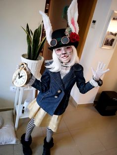 a woman dressed up as a rabbit holding an alarm clock