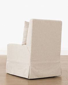 a beige chair sitting on top of a hard wood floor