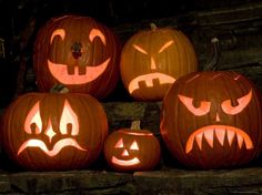 pumpkins with faces carved into them sitting on steps