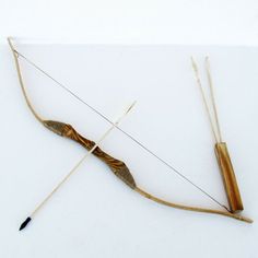 an arrow and bow on a white surface