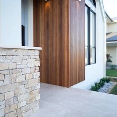 the front door of a house with stone and wood