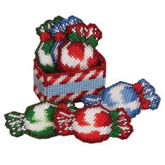 three pieces of cross stitched fabric with candy canes on them