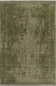 a green rug with an ornate design on the top and bottom, in different colors