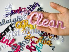 a hand is holding the word clean in different colors