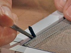 a person cutting fabric with a pair of scissors