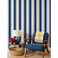 a chair and table in front of a striped wall