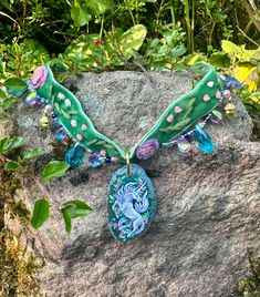 This is a handmade velvet choker with a handpainted pendant featuring a forest unicorn. The choker is adorned with handsewn beads around the edges. Measures 35cm + 5cm extension. Velvet Choker, Beaded Choker, Hand Sewing, Sticker Paper, Forest, Velvet, Hand Painted, Accessory Gift, Beads