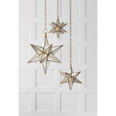 three gold stars hanging from chains