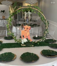 the table is set with plates and napkins for an animal themed wedding reception at disney's animal kingdom