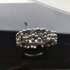 This is a special multisphere ring. It combines over 100 granules of various sizes.  It is made by combining Sterling silver and Argentium silver. Argentium silver is special because of its brigth luster and resistancy to tarnish.  In random spheres there are Swarovski diamonds set in.  The ring size is 18.24 mm, it is size 8, but due to the bands convex shape it would also fit slightly larger sizes even up to size 9. The ring weights 9.3 g. - 0.3287533 oz. Because the band is 4 mm thick it is m Argentium Silver, Rings Statement, Statement Rings, Jewelry Rings, Ring Size, Bubbles, Diamonds, Band, Sterling Silver