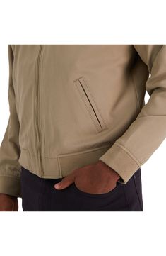 This classic full front zip bomber features a ribbed collar, hem and cuffs. Fully lined, that streamlines the appearance of this fashionable jacket. Additional features include a welt pocket, double welt front pockets and wicking performance within the fabric. Stand collar Long sleeves Zipper front Dual welt pockets Ribbed cuffs and hem Solid Stretch woven 50% polyester, 50% recycled polyester Dry clean Imported Model stats: 6'1" height, 32" waist. Model is wearing size M. Wardrobe Stand, Classic Jacket, Zipper Jacket, Most Favorite, Jacket Style, Welt Pockets, Welt Pocket, Stand Collar, Front Zipper