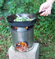 an outdoor stove with hot dogs cooking in it and the instructions for how to use it