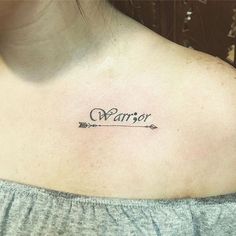 a woman with a tattoo on her shoulder that says,'warrior'in cursive writing