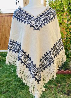 These authentic "Quexquemetl" are handwoven by indigenous artisans in Hueyapan Puebla. Every design is unique, embroidered with creativity, love and incredible skill. Simply beautiful! Measuring approximately 34" wide by 26'' long, one size should fit all adults. Traditional Fringe Poncho One Size, Traditional Fringed Poncho Shawl, Traditional Festival Poncho With Woven Motifs, Traditional Embroidered Poncho For Winter, Traditional Embroidered Winter Poncho, Handmade Artisan Poncho For Festivals, Winter Festival Embroidered Poncho, Traditional Handwoven Poncho, Handmade One-size Folk Poncho