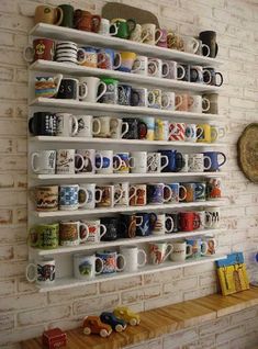 coffee mugs are lined up on the wall