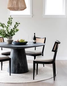 a round table with four chairs around it