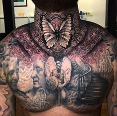 the back of a man's chest with tattoos on it