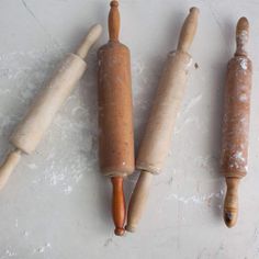 three different types of breadsticks are on the counter top, and one is made out of wood