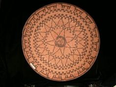 a basket that is sitting on top of a table in front of a black background