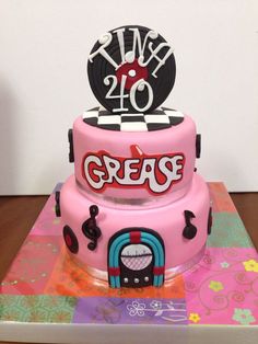 a pink cake with the number twenty on top and an image of a dj's head