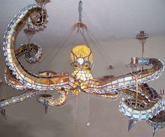 a chandelier hanging from the ceiling in a room with many lights on it