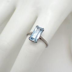 Art Deco 18K (.750) white gold ring with emerald-cut Aquamarine stone centerpiece. The stone is 2.5ct, measuring 12mm x 6.1mm x 4.8mm. This marvelous ring is a size 6 and 13 mm at the widest. EA3171 Formal Octagon Sapphire Ring In Platinum, Modern Topaz Ring With Rectangular Stone For Formal Occasions, Modern Formal Topaz Ring With Rectangular Stone, Platinum Baguette Cut Gemstone Ring, Platinum Rings With Baguette Cut Gemstone, Baguette Cut Platinum Gemstone Rings, Platinum Rings With Emerald Cut Gemstone, Timeless Rectangular Prong Set Emerald Ring, Timeless Rectangular Emerald Ring With Prong Setting