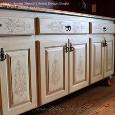 the cabinets in this kitchen are painted white and have floral designs on them, as well as black handles