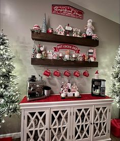 a christmas display in the corner of a room with shelves and decorations on top of it