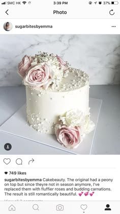 a white cake with pink flowers on top is shown in the instagramr above it