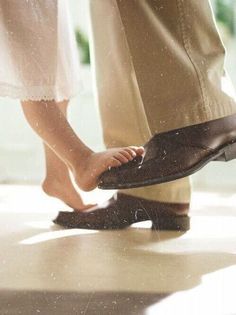 two people standing next to each other wearing shoes