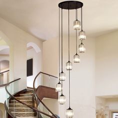 a chandelier hanging from the side of a staircase with glass balls on it